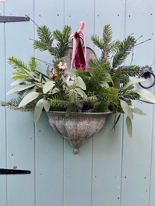 How to create festive door decor using a wall planter