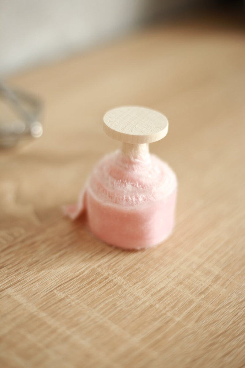 velvet ribbon on wooden spool, blush