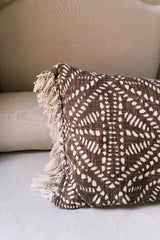brown cushion with fringe