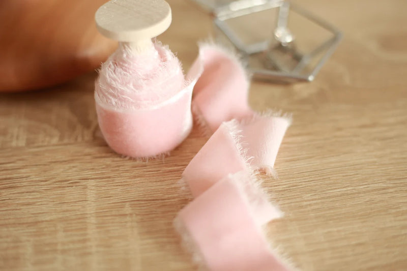 velvet ribbon on wooden spool, blush