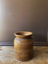 ceramic brown vessel with grooves